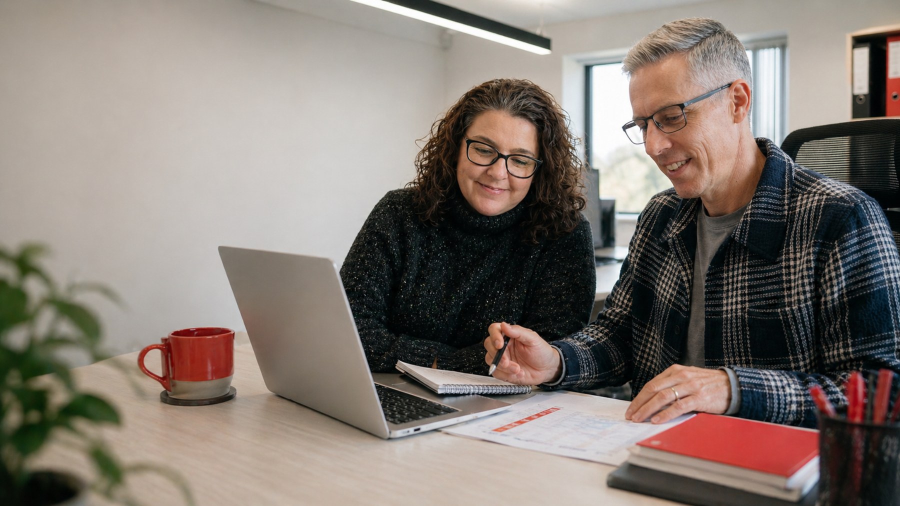 Teresa and Rich working together at TML Bookkeeping in their office